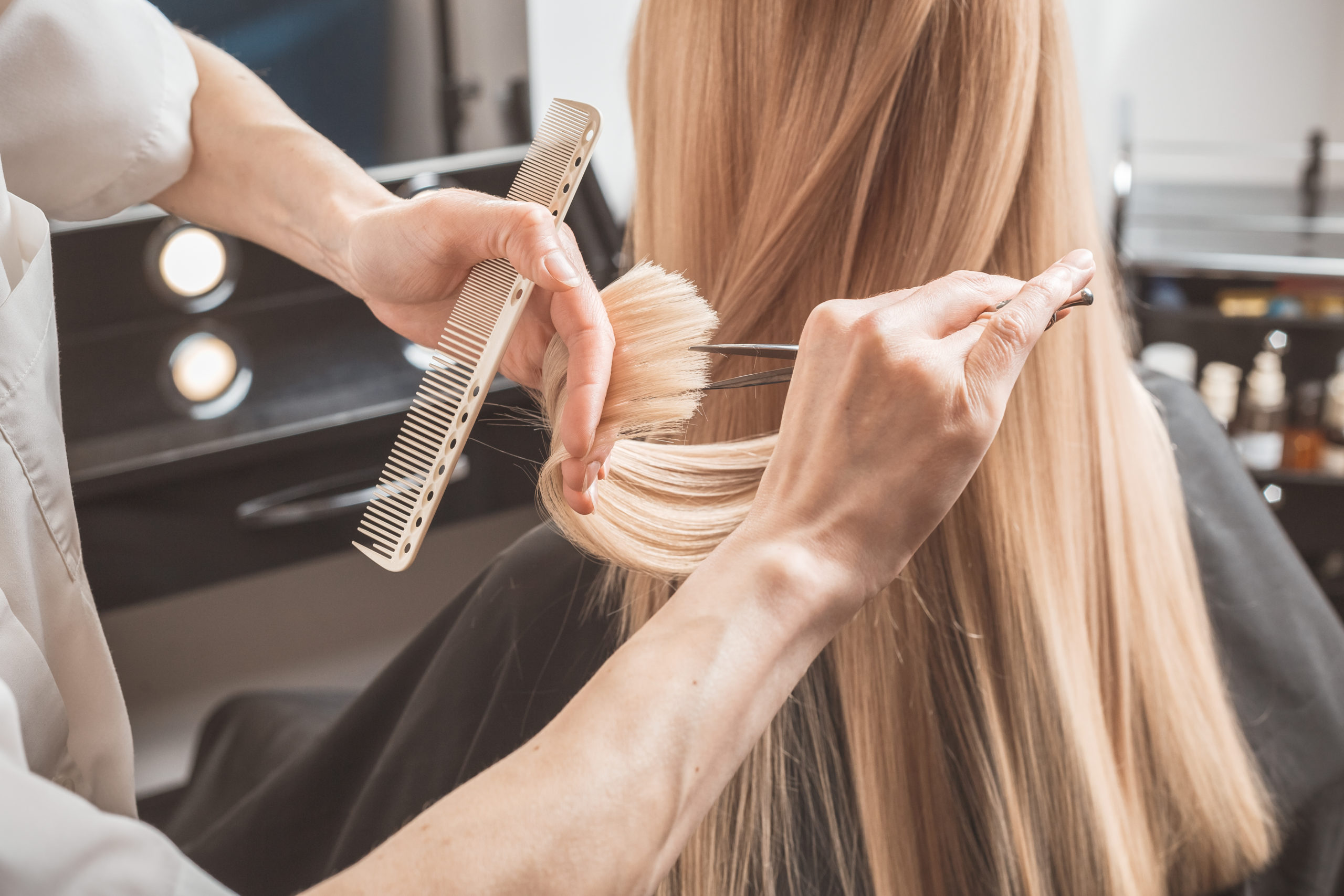 Hairdresser Cutting Long Blonde Hair