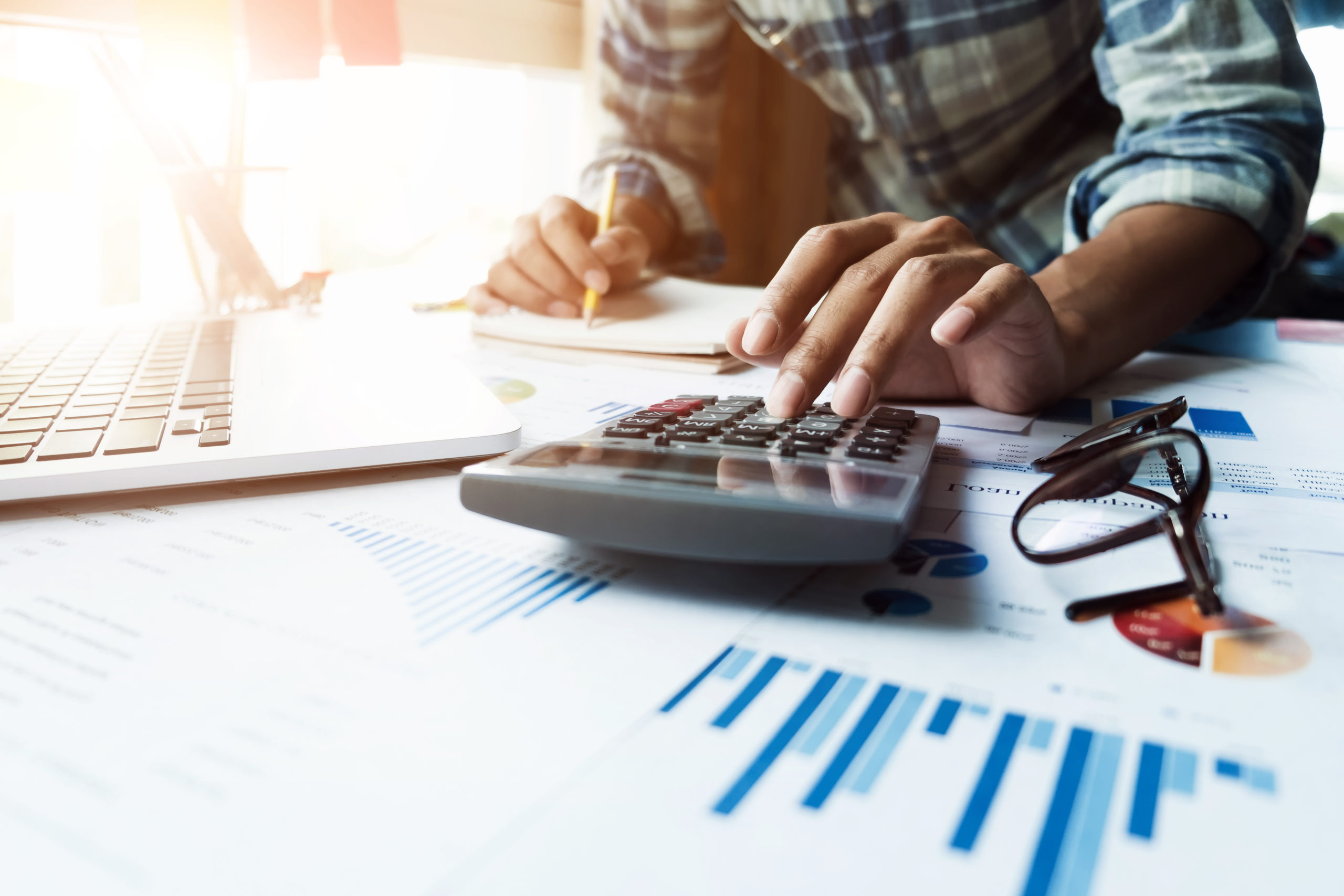 Businessman Typing On Calculator