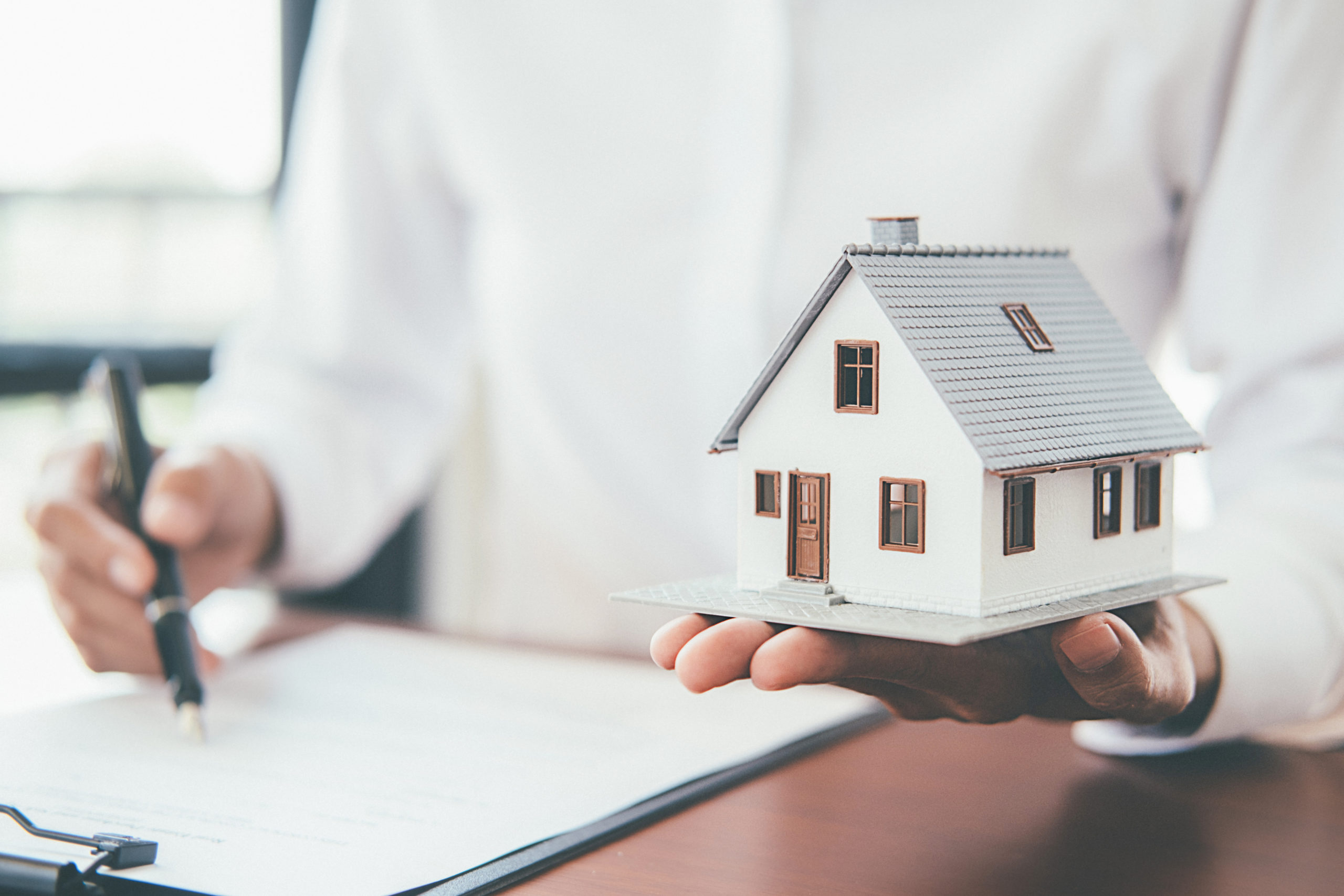 Businessman Holding House Model